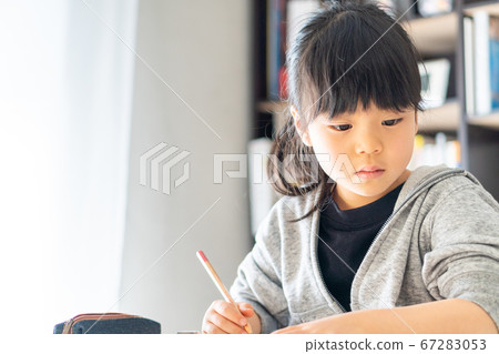 Girl doing home-based learning online. Girl doing home-based learning online. 67283053