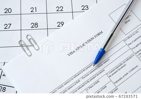 Typical Visa application form and blue pen on 67283571