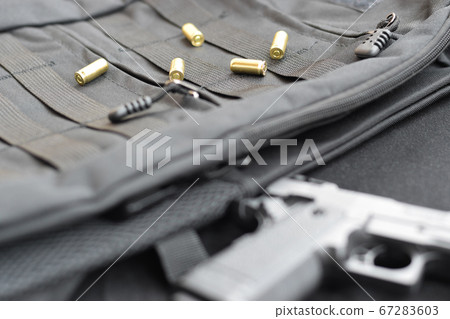 9mm bullets and pistol lie on a black tactical 67283603