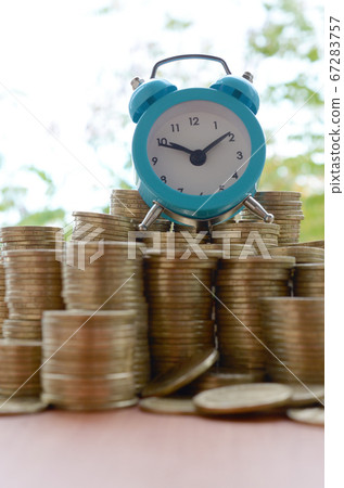 Blue alarm clock on big amount of shiny ukrainian 67283757