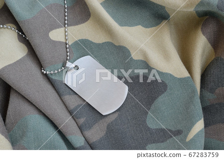 Silvery military beads with dog tag on camouflage Silvery military beads with dog tag on camouflage 67283759