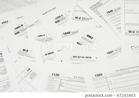 Many tax form blanks lies on table close up. Tax Many tax form blanks lies on table close up. Tax 67283803