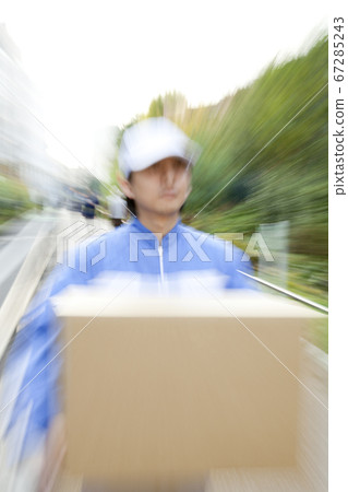 Courier carrying luggage 67285243