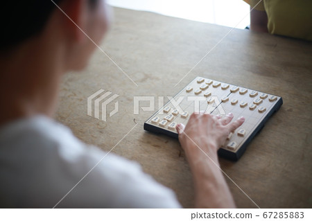 A couple pointing at shogi A couple pointing at shogi 67285883
