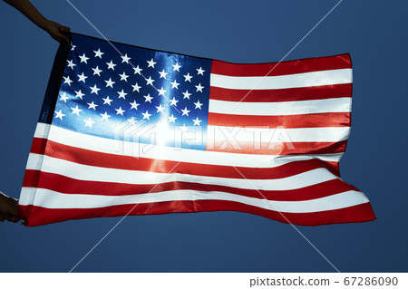 man waving an American flag on the wind man waving an American flag on the wind 67286090