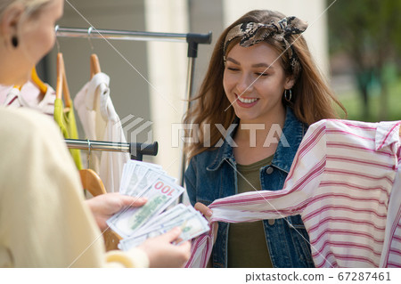 Nice young woman holding money in the hand Nice young woman holding money in the hand 67287461