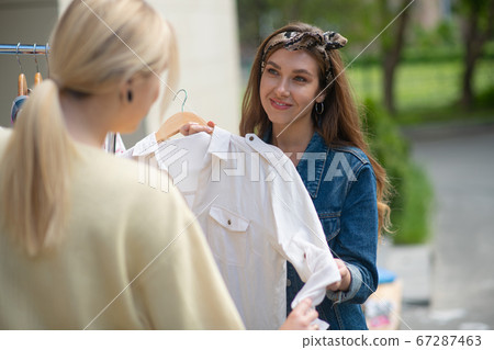 Delighted pretty woman looking at her client 67287463