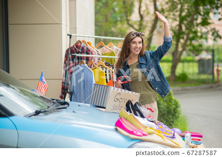 Nice positive woman waving with her hand 67287587