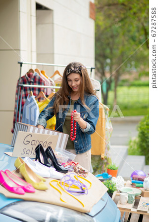 Pretty young woman holding a red necklace 67287588