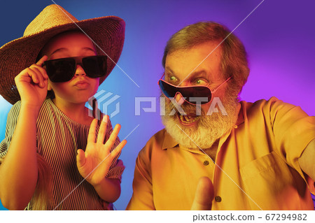 Senior man, grandfather having fun and spending time together with girl, granddaughter. Joyful elderly lifestyle concept Senior man, grandfather having fun and spending time together with girl, granddaughter. Joyful elderly lifestyle concept 67294982