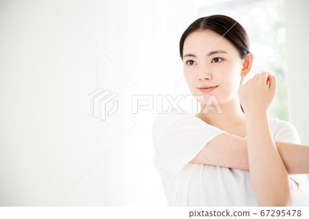 A young woman stretching A young woman stretching 67295478