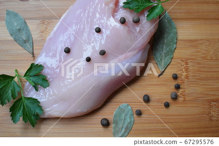 Chicken fillet, parsley, pepper, bay leaf on a 67295576