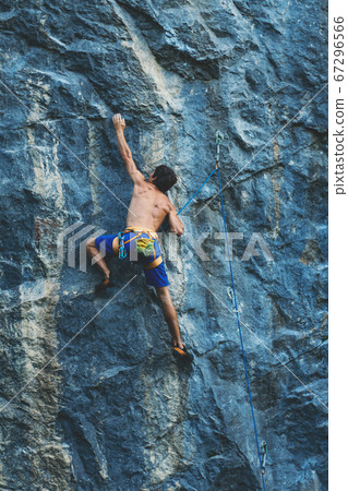 Man climbs a rock. Man climbs a rock. 67296566