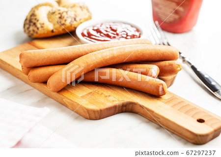 Fresh frankfurter sausages with bun and ketchup. Fresh frankfurter sausages with bun and ketchup. 67297237