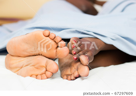 feet of people in the bed feet of people in the bed 67297609