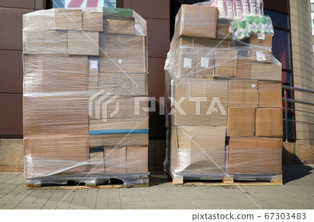 On city street are pallets with boxes in film On city street are pallets with boxes in film 67303483