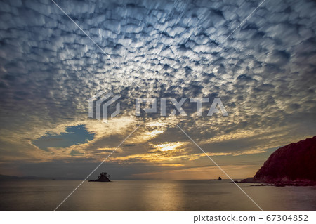 Impressive clouds illuminated by the setting sun 67304852