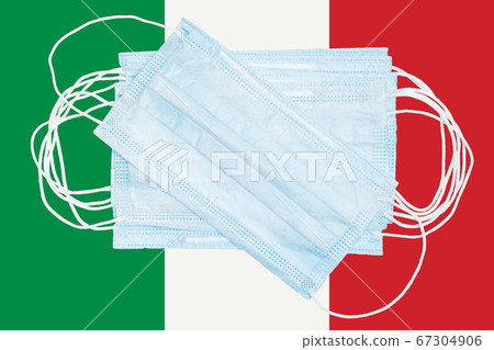 Group protective medical surgical face masks on background colors national flag of Italy. Concept of disease in country and global world 67304906
