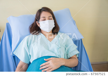 Asian woman is sick has a high fever, sneezing, is Asian woman is sick has a high fever, sneezing, is 67307521