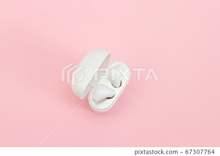 Wireless headphones in case on a pink background. Wireless headphones in case on a pink background. 67307764