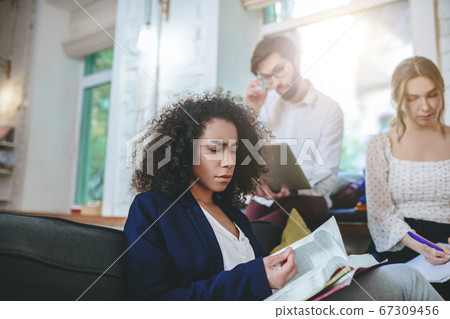 Girl flipping book, girlfriend writing with pen, guy with laptop. Girl flipping book, girlfriend writing with pen, guy with laptop. 67309456