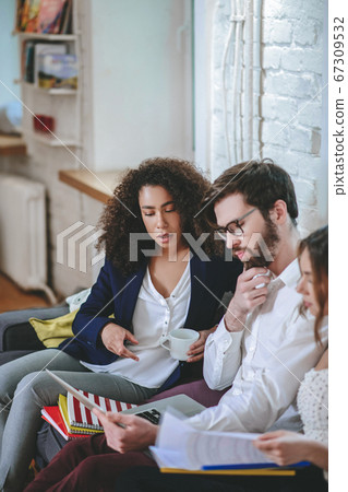 Bearded guy with laptop long-haired girl with coffee talking Bearded guy with laptop long-haired girl with coffee talking 67309532