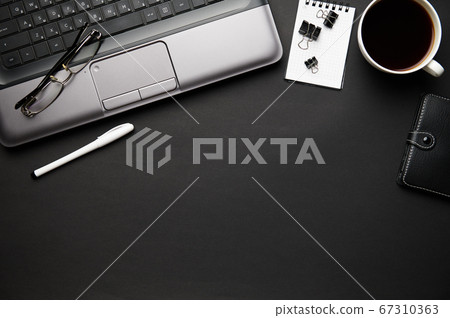 Top view of modern black office desk with laptop, Top view of modern black office desk with laptop, 67310363