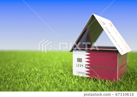 Flag of Qatar on bank card house in the grass. Mortgage related 3D rendering 67310618
