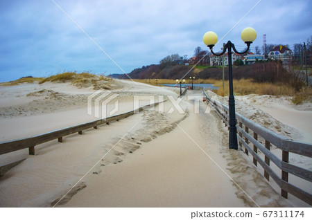 sand-covered promenade, sea promenade after storm sand-covered promenade, sea promenade after storm 67311174
