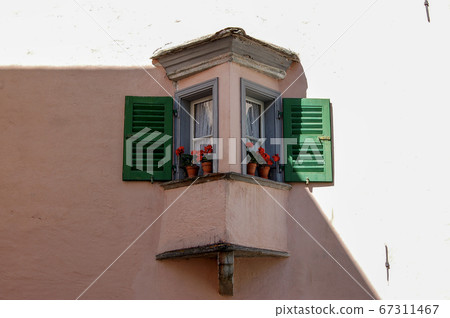 Small balcony with windows and flowers - Tirano Lombardy Italy 67311467