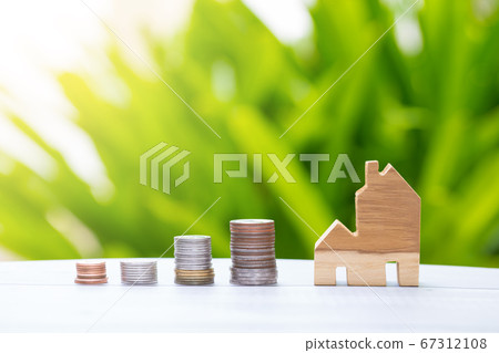 coin stacks and home model with nature background 67312108