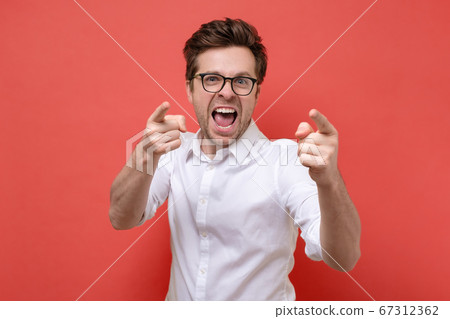smiling man pointing fingers at camera, picking you smiling man pointing fingers at camera, picking you 67312362
