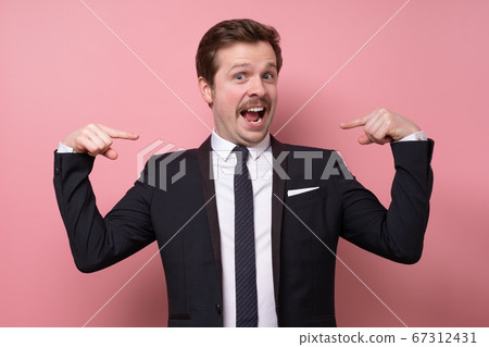 Man proud of himself pointing on his chest over pink background. I am the best concept. Man proud of himself pointing on his chest over pink background. I am the best concept. 67312431