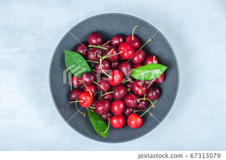 Cherry with leaf on plate and water drops on Cherry with leaf on plate and water drops on 67313079