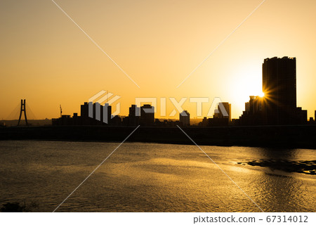 silhouette of buildings with river at sunset silhouette of buildings with river at sunset 67314012