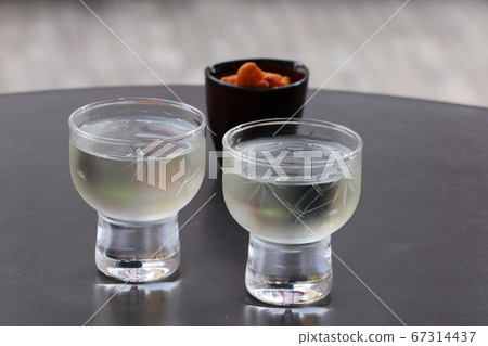 Two cups of sake with Japanese crackers Two cups of sake with Japanese crackers 67314437