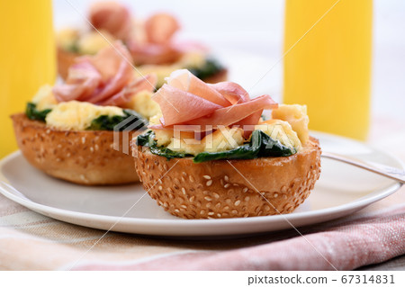 Breakfast. Bun with cheese, spinach, ham Breakfast. Bun with cheese, spinach, ham 67314831