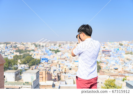 Asian young man photographing view of Jodhpur the blue city  67315912