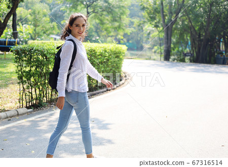 Young beautiful woman relaxation and working at park in summer holiday. Young beautiful woman relaxation and working at park in summer holiday. 67316514