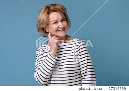 Happy confident old senior woman smiling with her ams crossed Happy confident old senior woman smiling with her ams crossed 67316869