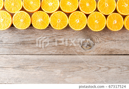 Orange slices on wooden background with copyspace Orange slices on wooden background with copyspace 67317524