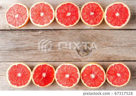 Grapefruit slices on wooden table. Top view Grapefruit slices on wooden table. Top view 67317528
