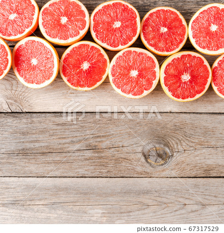 Juicy grapefruit halves on wooden table. Top view Juicy grapefruit halves on wooden table. Top view 67317529