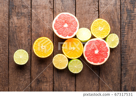 Fresh citruses on wooden background Fresh citruses on wooden background 67317531