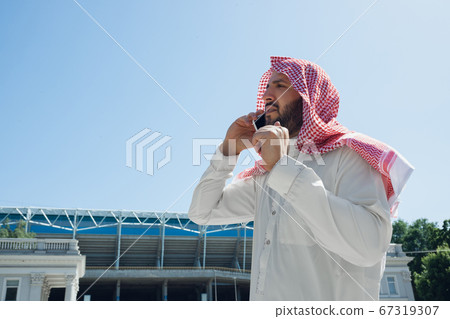 Smiling rich arabian man's buying real estate in the city 67319307