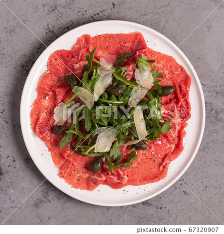 Marbled beef carpaccio with arugula, capers and Marbled beef carpaccio with arugula, capers and 67320907