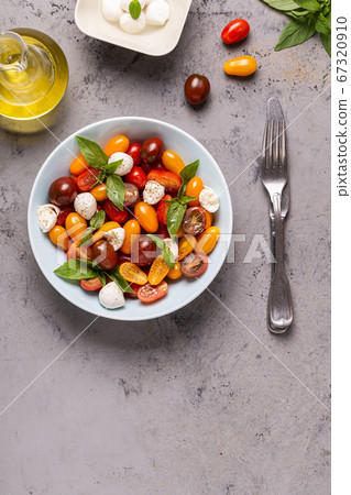 Italian caprese salad with tomatoes, mozzarella Italian caprese salad with tomatoes, mozzarella 67320910