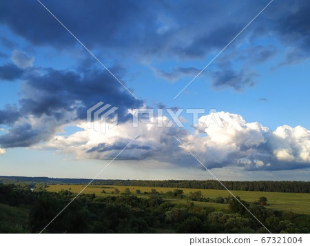 Dark blue and white clouds over the fields and the river, smart 67321004