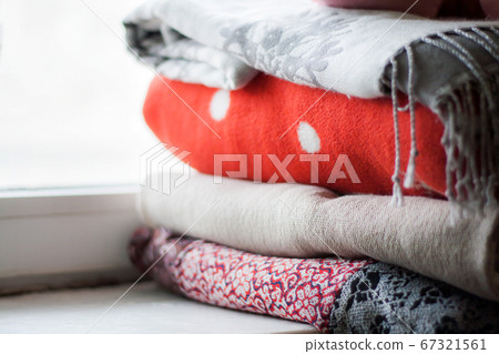 a stack of plaids on the windowsill a stack of plaids on the windowsill 67321561
