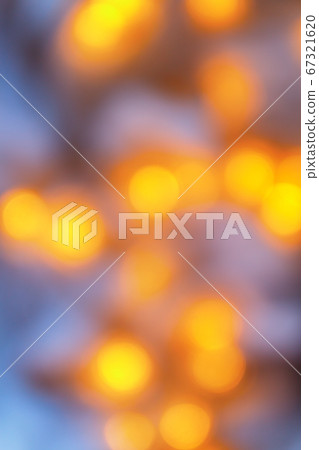 Background from blurry light lights of fir-tree garland on dark. Copy space 67321620